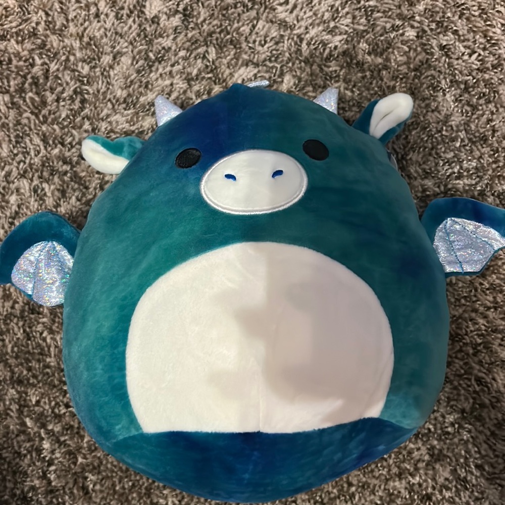 Colorful green and blue squishmallow tag in good shape.